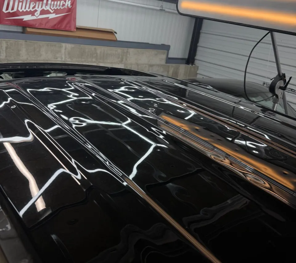 Hail damage on a black roof before repair