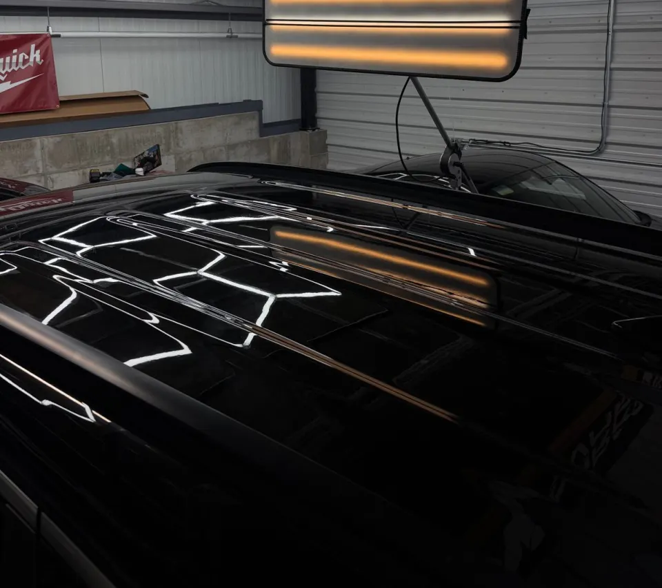 Hail damage on a black roof after repair