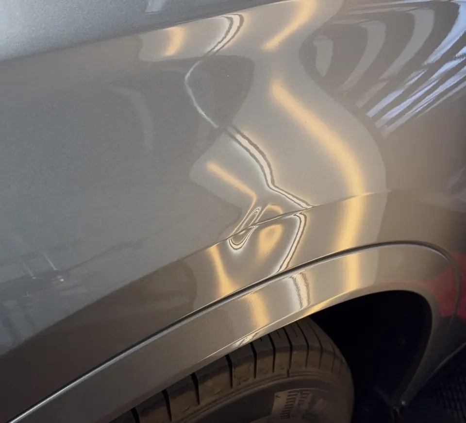 Rear fender dent before repair